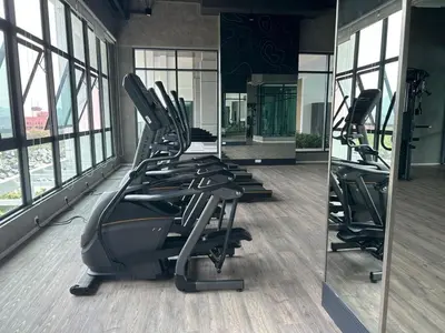 a gym with treadmills and mirrors in a building at Onsen Ipoh by Plush in Ipoh