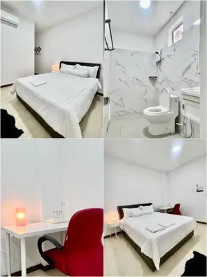 three pictures of a bedroom with a bed and a toilet at Three Homestay in Perai