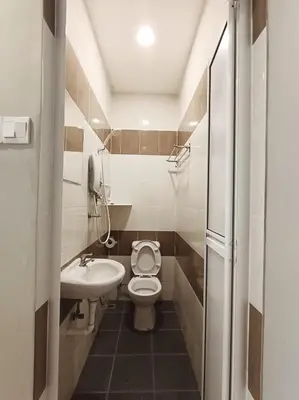 a small bathroom with a toilet and a sink at Lung Tok Entreprise \u8336\u9986\u6c11\u5bbf in Bukit Mertajam