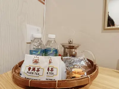 a tray with bottles of water and food on a table at Lung Tok Entreprise \u8336\u9986\u6c11\u5bbf in Bukit Mertajam