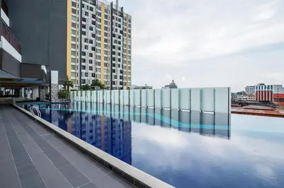 a building with a swimming pool in front of a building at THE MAJESTIC IPOH B7 by ZamanJa in Ipoh