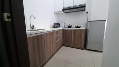 a kitchen with a sink and a refrigerator at THE MAJESTIC IPOH B7 by ZamanJa in Ipoh