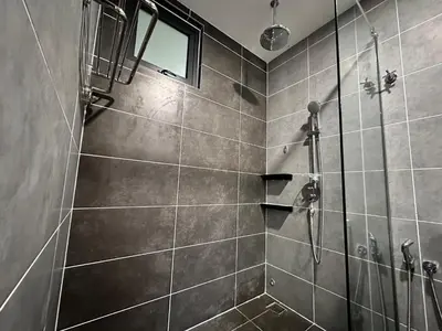 a bathroom with a shower with gray tiles at Hygge Living@Sunway Onsen in Tambun