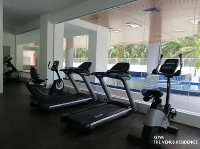 a gym with treadmills and a row of exercise bikes at 5D Homestay in Sitiawan