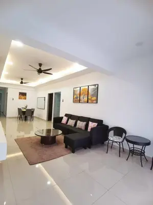 a living room with a black couch and tables at 5D Homestay in Sitiawan