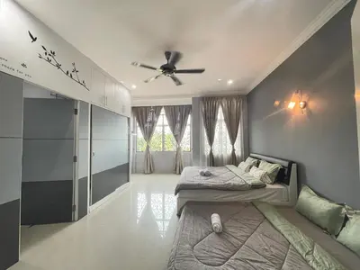 a bedroom with a bed and a ceiling fan at Art Homestay 4 Bedrooms House by Mr Homestay in Teluk Intan