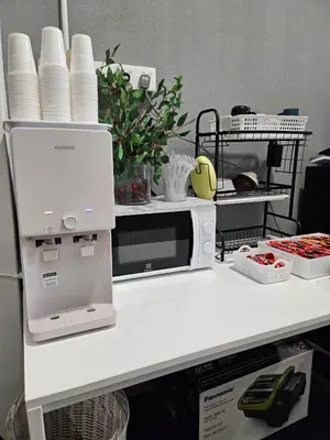 a white counter top with a microwave and dishes at Le Melur Single Bed in George Town