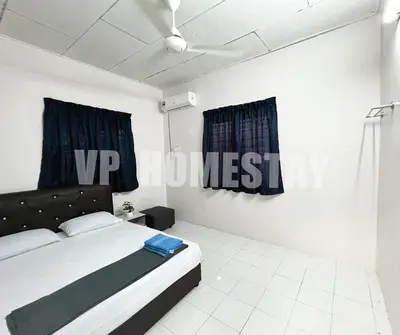 a bedroom with a bed and a sign on the wall at VP Homestay - Malay Only in Ipoh