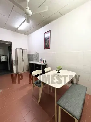a room with a table and chairs and a kitchen at VP Homestay - Malay Only in Ipoh
