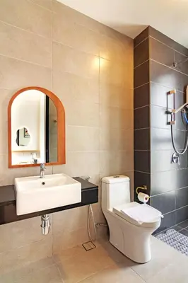 a bathroom with a sink and a toilet and a mirror at Urban Suites, Classic Collection by Stellar ALV in Jelutong