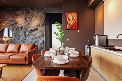 a kitchen and dining room with a wooden table at Urban Suites, Spectre Collection by Stellar ALV in Jelutong