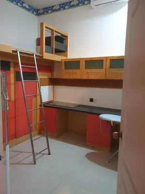 a room with a desk and a ladder at Chor Residence Homestay in Ipoh