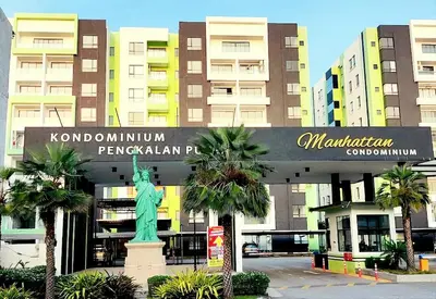 a large building with a statue in front of it at Ipoh Manhattan Waterpark View 3BR Condo by City Home Empire MHD704 in Ipoh
