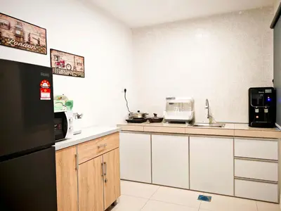 a kitchen with white cabinets and a black refrigerator at Ipoh Manhattan Waterpark View 3BR Condo by City Home Empire MHD704 in Ipoh