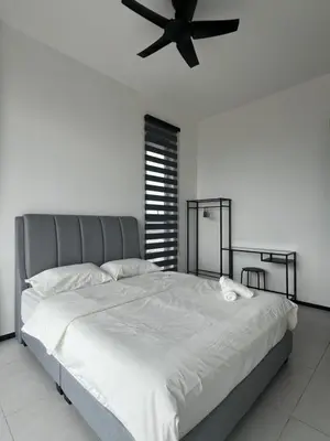 a bedroom with a large bed with a ceiling fan at Urban Suites - George Town, Penang in Jelutong