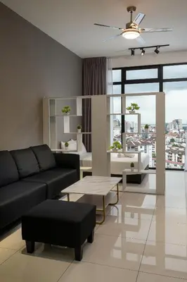 a living room with a couch and a table at Penang KTHOME Beacon Executives suite in George Town