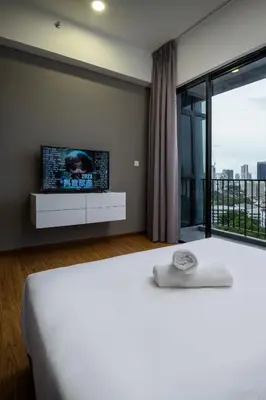 a bedroom with a bed with a tv on the wall at Penang KTHOME Beacon Executives suite in George Town