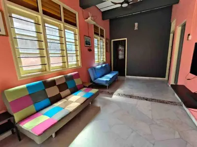 a living room with a couch and a chair at Wi-Fi 100MB Free Ipoh Happy Big House SemiD TH24 16 pax in Ipoh