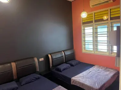 a room with two beds and a window at Wi-Fi 100MB Free Ipoh Happy Big House SemiD TH24 16 pax in Ipoh