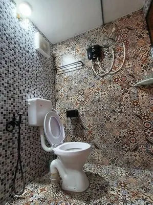 a bathroom with a toilet and a phone on the wall at Wi-Fi 100MB Free Ipoh Happy Big House SemiD TH24 16 pax in Ipoh