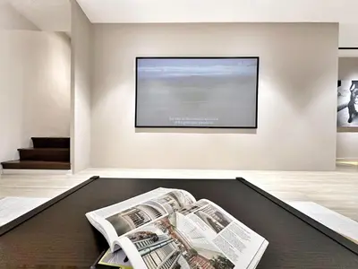 a living room with a tv on a wall at Designer Guesthouse Pulau Tikus & Gurney Drive, Georgetown, Penang in George Town