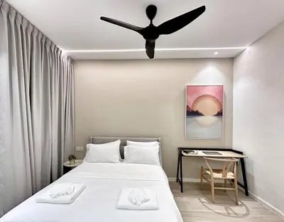 a bedroom with a bed with a ceiling fan at Designer Guesthouse Pulau Tikus & Gurney Drive, Georgetown, Penang in George Town