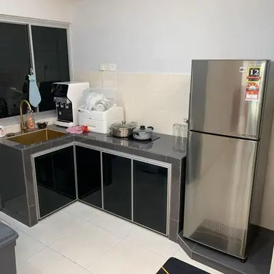 a kitchen with a stainless steel refrigerator and a microwave at Sekinchan Simple Love SeaHouse - PaddyView 8-7A in Sekincan
