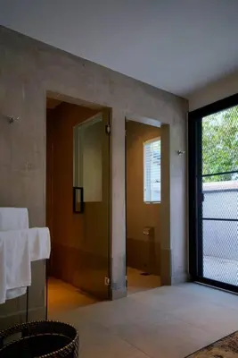 a bathroom with a glass door and a mirror at Quint Residence, Georgetown - Rustic Heritage Guesthouse by ALV in George Town
