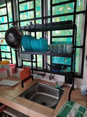 a kitchen counter with a sink and a sink at Hakimi Homestay in Tanah Rata