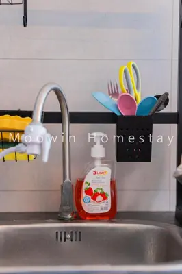 a bottle of dish detergent sitting next to a kitchen sink at Comfy Suite by Moowin in Perai