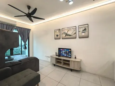 a living room with a couch and a ceiling fan at Summer Cozy Big Studio in Perai
