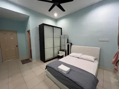 a bedroom with a bed and a ceiling fan at JZ at Sungai Besar Single Storey Semi-D in Sungai Besar