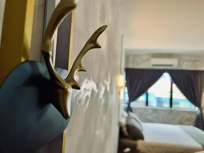 a hotel room with a deer head in a window at The Ash Ipoh - Family Suite in Ipoh