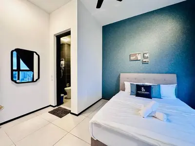a bedroom with a bed with a blue wall at New URBAN SUITES Seaview Family Homestay by Urban Staycation HENG LOD COSY in Jelutong