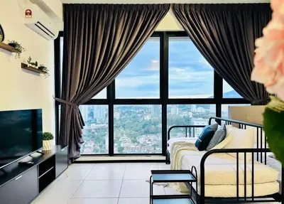 a bedroom with a bed and a large window at New URBAN SUITES Seaview Family Homestay by Urban Staycation HENG LOD COSY in Jelutong