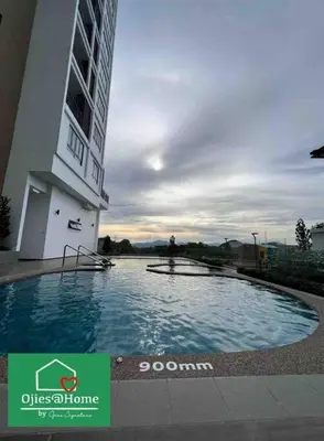 a large swimming pool in front of a building at Ojieshome 1BR Sunway Onsen Tambun in Tambun