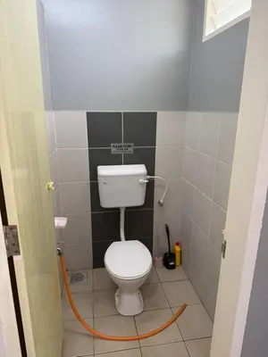 a bathroom with a white toilet in a room at AISY HOMESTAY KULIM/LUNAS in Kulim