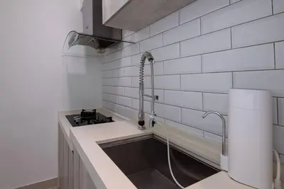 a kitchen with a sink and a stove at XBox, Karaoke, Foosball, PoolTable, IceHockey, Ping Pong, Board Games in George Town