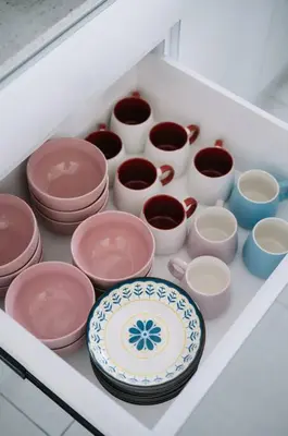 a drawer filled with different colored bowls and cups at NEW Infinity Pool Seaview 3Bedrooms 2Carparks 262 in Jelutong
