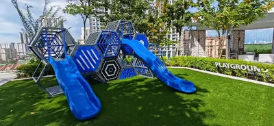 a playground in a park with a blue slide at Vanilla Cottage - Urban Suites by Ocean Luxe in Jelutong