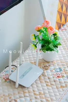 a table with a keyboard and a vase of flowers at Cozy&Comfy Suite Room Perai in Perai