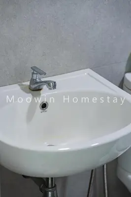 a white sink in a bathroom next to a toilet at Cozy&Comfy Suite Room Perai in Perai
