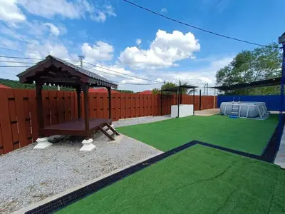 a backyard with a gazebo and green grass at Home MH Casa Damai Private Pool at Sungai Petani in Sungai Petani