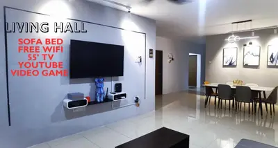 a living room with a tv and a table with chairs at Ipoh Water Park(14pax) Homestay@HopeStay in Ipoh