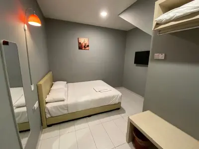 a small room with a bed and a mirror at DS Hotel in Ipoh