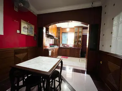 a kitchen with a table and chairs in a room at Wan Homestay Kulim Hi-Tech Mslliim only in Kulim