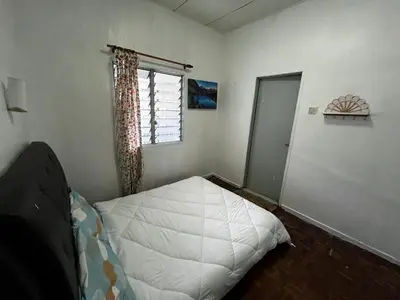a bedroom with a white bed and a window at Wan Homestay Kulim Hi-Tech Mslliim only in Kulim