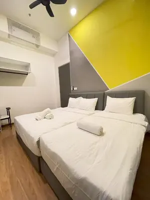 a bedroom with two beds with white sheets at Penang Georgetown KT Home for 8 pax in George Town