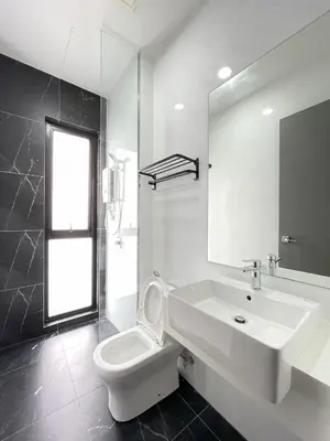 a bathroom with a sink and a toilet and a mirror at Penang Georgetown KT Home for 8 pax in George Town