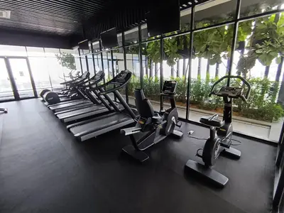 a gym with a bunch of cardio equipment in a room at Penang Georgetown KT Home for 8 pax in George Town